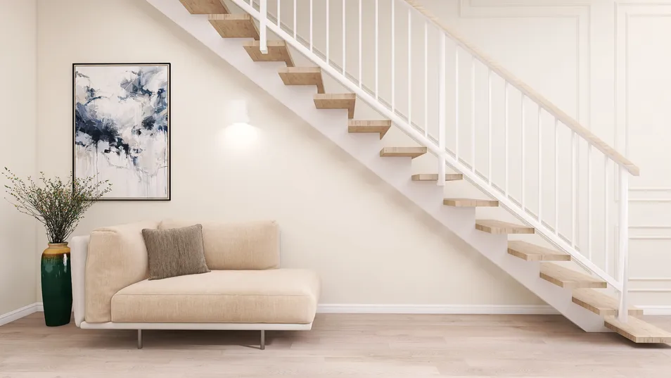 A cozy sofa arranged under a staircase in a contemporary style, showcasing an inviting living space with neutral tones and modern decor. features Homestyler's real-time 3D rendering for design previews.